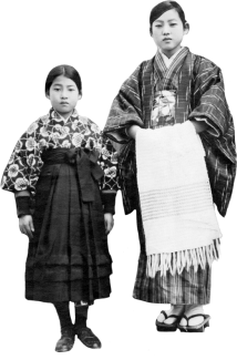 A Japanese Canadian woman and young girl in traditional Japanese clothing. The woman is holding a blanket.
