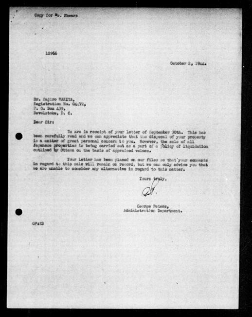 Scanned black-and-white microfilm of a typewritten reply letter to Saijiro Wakita from government representative George Peters regarding dispossession of their property. Includes handwritten signature from author.