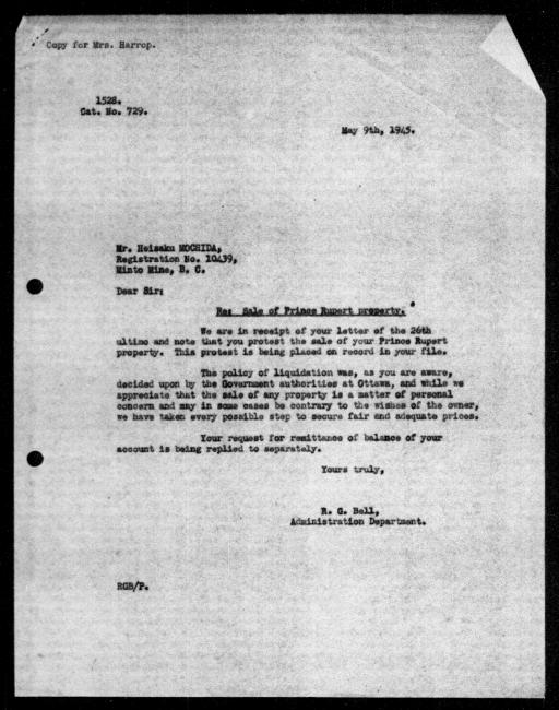 Scanned black-and-white microfilm of a typed reply letter to Heisaku Mochida from government representative RG Bell regarding dispossession of their property.